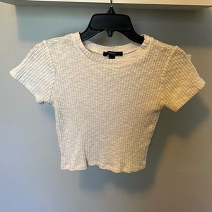 White cropped top with lacey fabric that’s ribbed